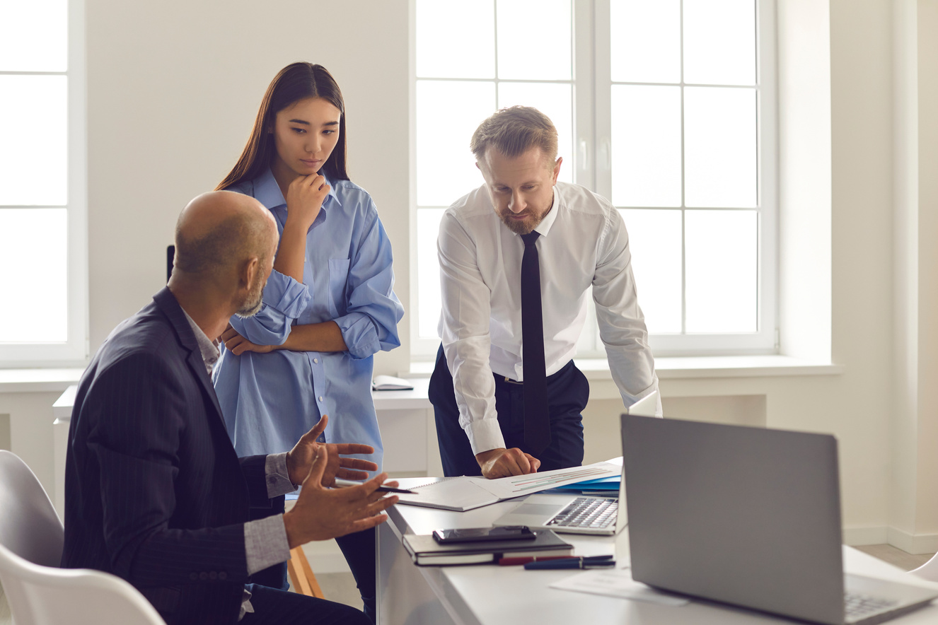 Serious Employees Listening to Boss's Advice and Instructions While Solving Work Project Problem