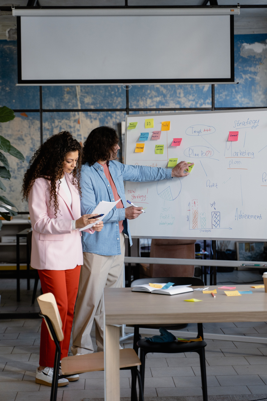 Male and Female Business Colleagues Presenting in the Office