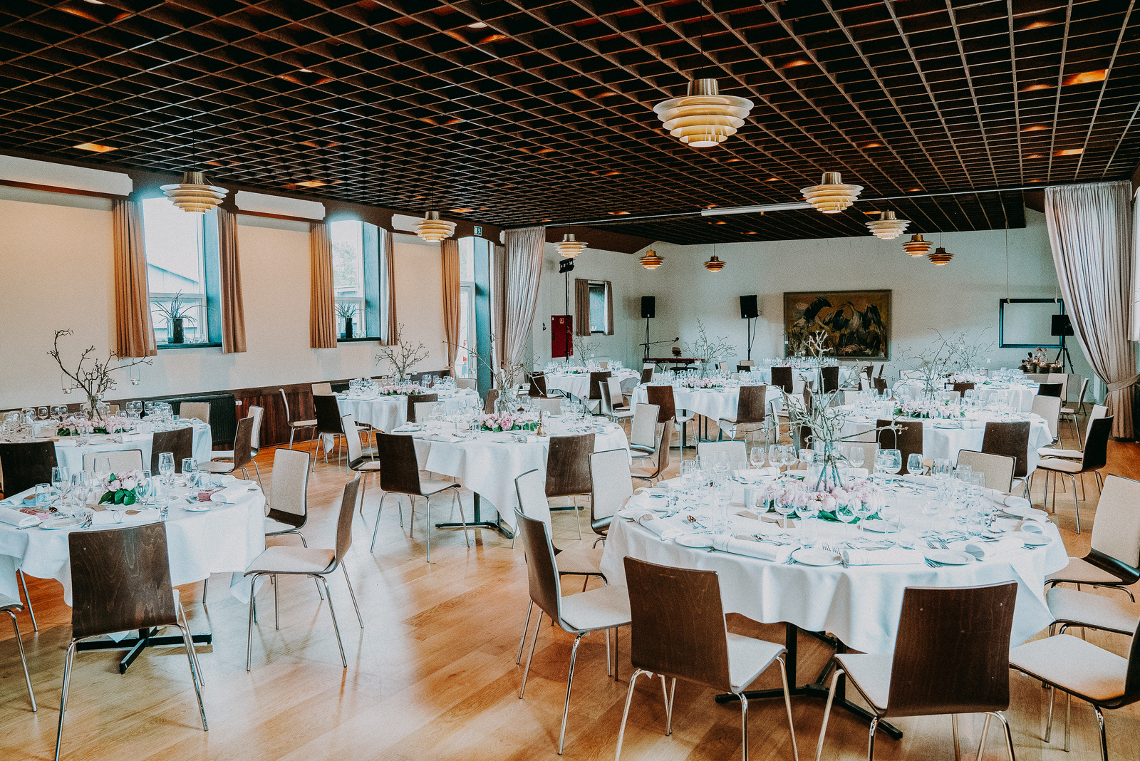 Round tables for guests in bright hall