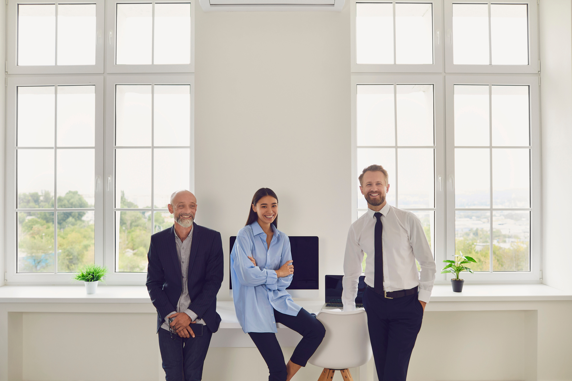 Happy Members of Diverse Company Staff Gather Together in Modern Spacious Office