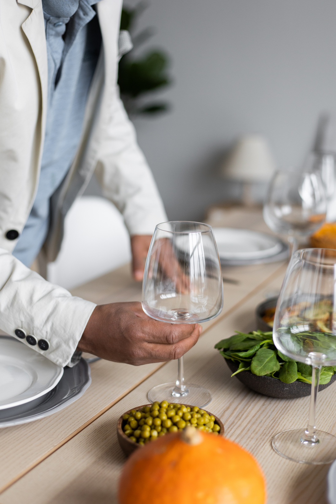 Crop man serving table for guests